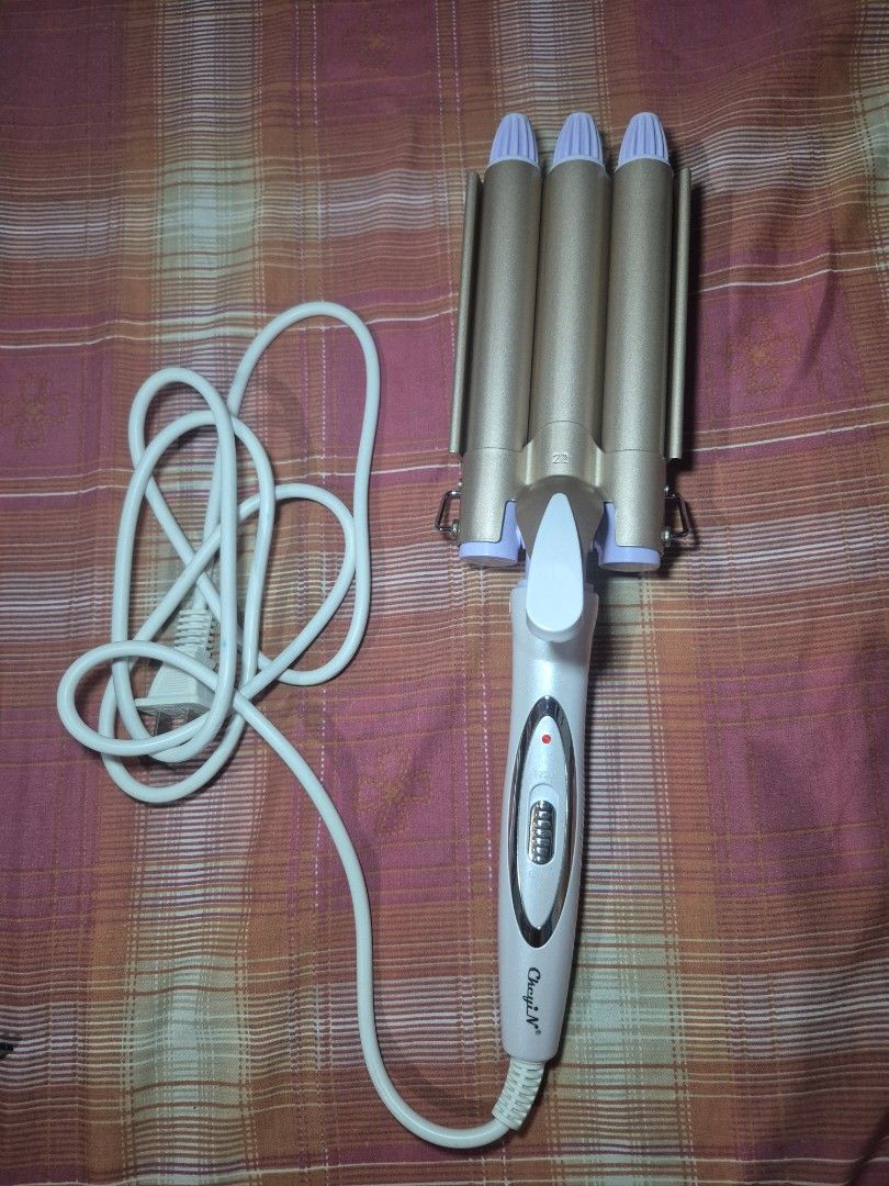 CheyiN 3-Barrel Hair Waver (Category: Hair) located in Bacoor. Submitted by Talsp (Listing ID 1439743364, Image 1). Description: Location: Bacoor, Cavite - CheyiN 3-barrel hair waver for beachy waves - White handle with temperature settings and indicator light - Gold barrels with purple tips - Includes a white power cord - Standard Philippine plug - Model number visible on the device.
