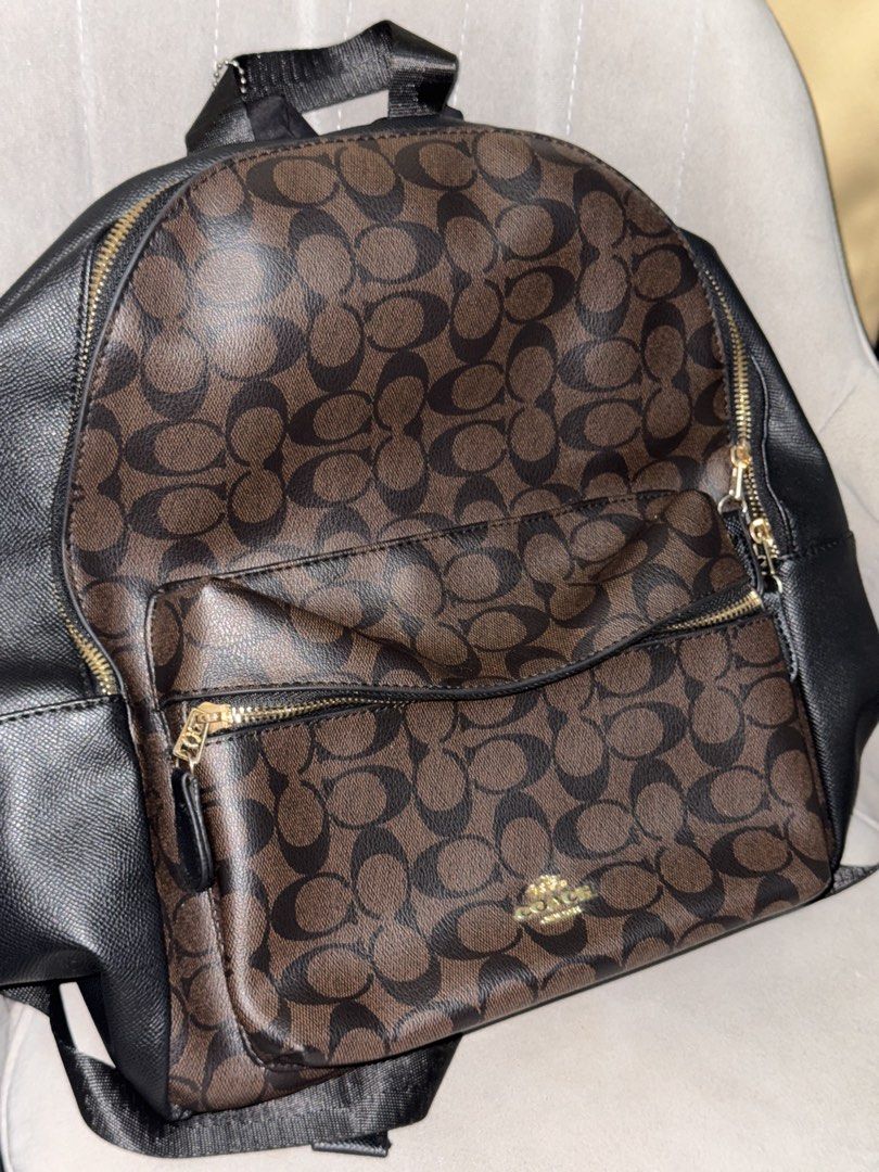 Class A Coach Signature Backpack (Category: Luxury Bags & Wallets) located in Las Pinas. Submitted by bookoffmnl (Listing ID 1439626869, Image 3). Description: - Signature brown and black pattern - Gold zipper and hardware - Front pocket - Black back and straps - Black interior with Coach label - Top handle.