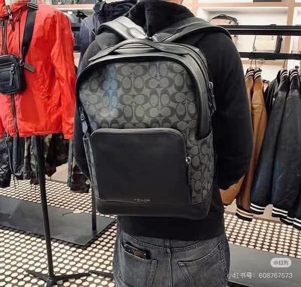 Coach Men's Signature Backpack (Category: Backpacks) located in Manila. Submitted by santosrich_419 (Listing ID 1439765237, Image 1). Description: - Authentic Coach backpack - Dark grey color with signature Coach pattern - Made of leather - Front pocket for easy access - Top handle for carrying versatility - Adjustable shoulder straps for comfort - Secure zipper closure - Features the Coach logo.