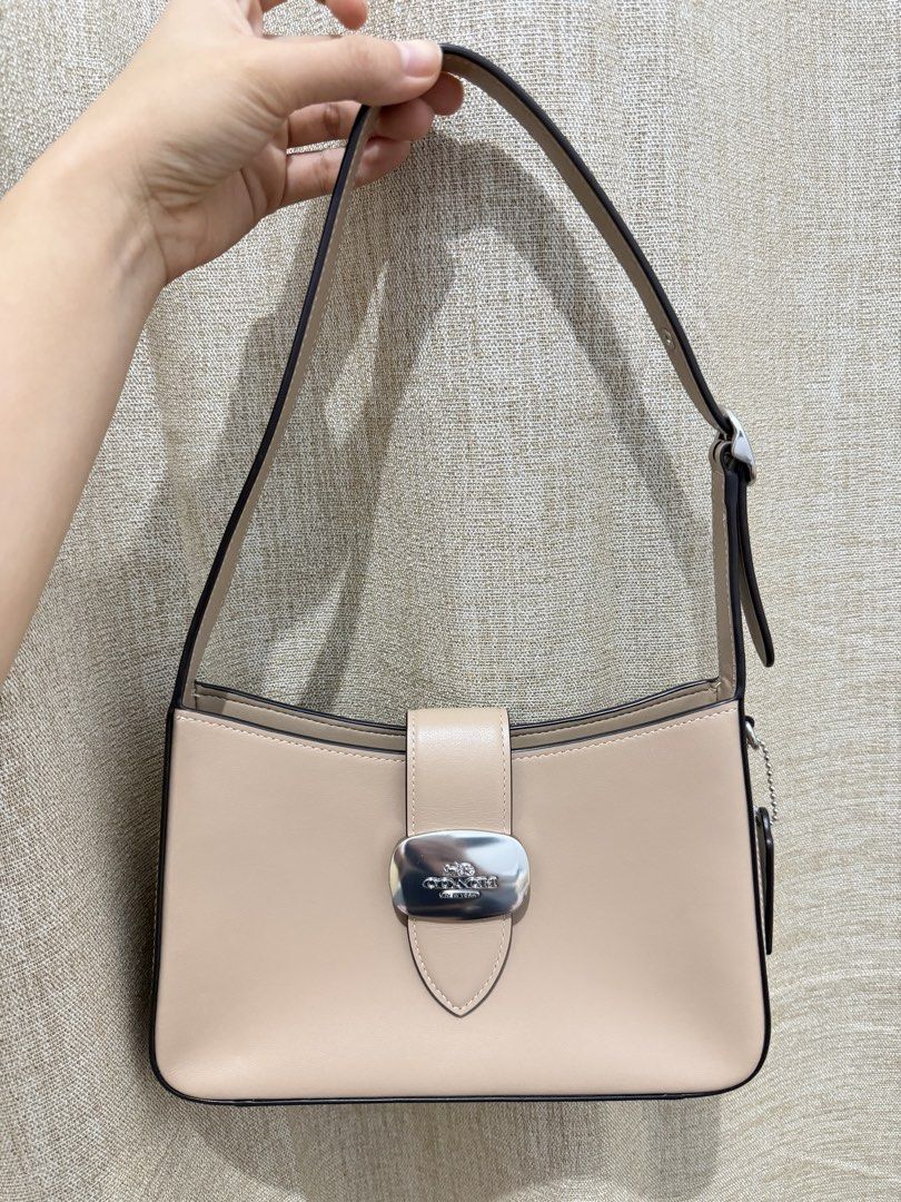 Coach Shoulder Bag (Category: Luxury Bags & Wallets) located in Tarlac. Submitted by rosie319 (Listing ID 1439752085, Image 1). Description: -From japan - Authentic Coach shoulder bag - Beige leather exterior - Silver-tone buckle closure - Single shoulder strap - Rectangular shape - Interior pocket - Coach logo detail.