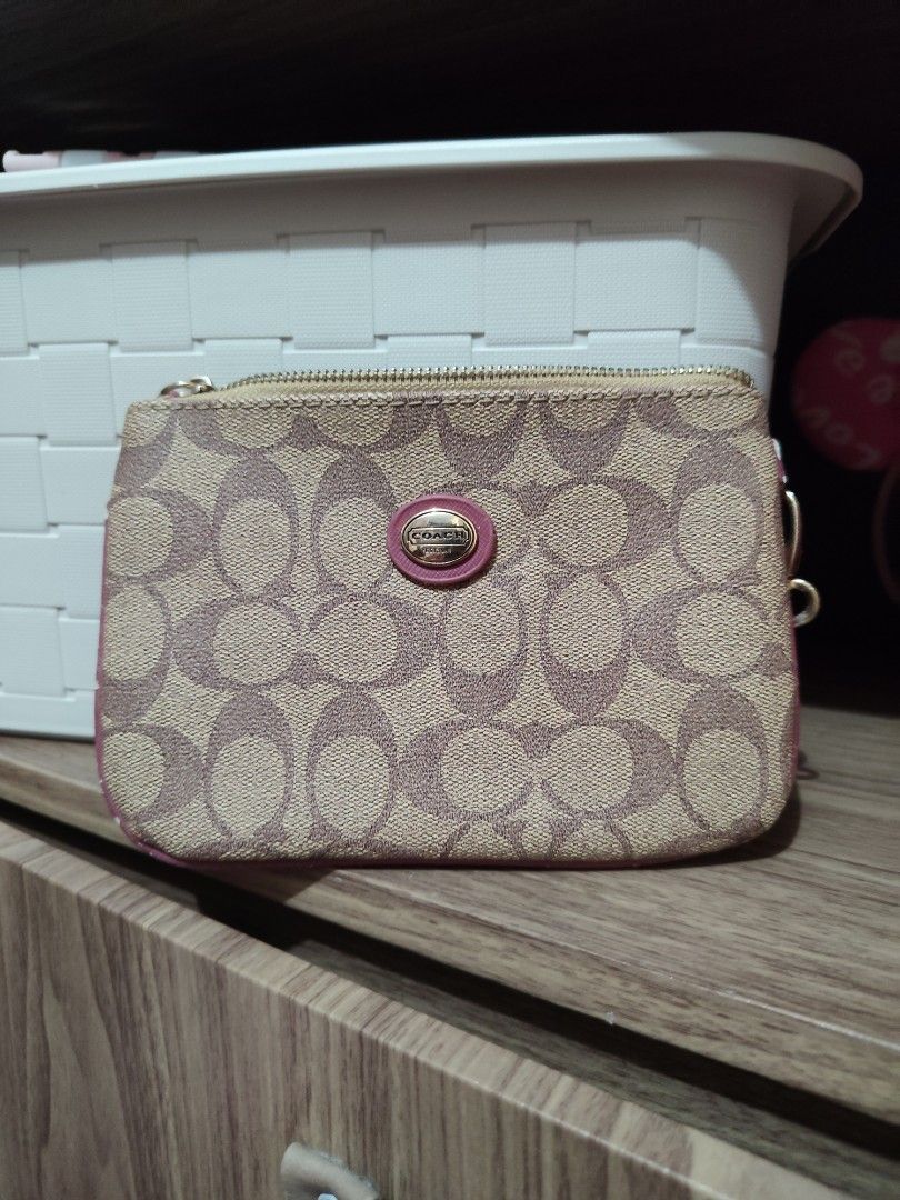 Coach Signature Zip Wallet (Category: Luxury Bags & Wallets) located in Angeles City. Submitted by rkasr (Listing ID 1439796413, Image 1). Description: - Coach signature zip wallet - Classic Coach pattern with pink accent - Black fabric interior with Coach logo - Zipper closure - Includes small ring - Minor wear on edges (only flaw).