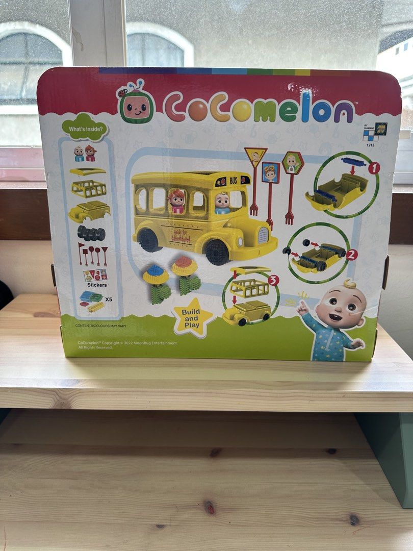 CoComelon School Bus Kit (Category: Kids Toys) located in Quezon City. Submitted by things2things (Listing ID 1439649483, Image 2). Description: - CoComelon School Bus Kit for kids aged 2+. - Includes a yellow school bus. - Features CoComelon characters. - Comes with build-and-play accessories. - Includes stickers and other fun elements. - Box shows contents like road signs and additional vehicles..