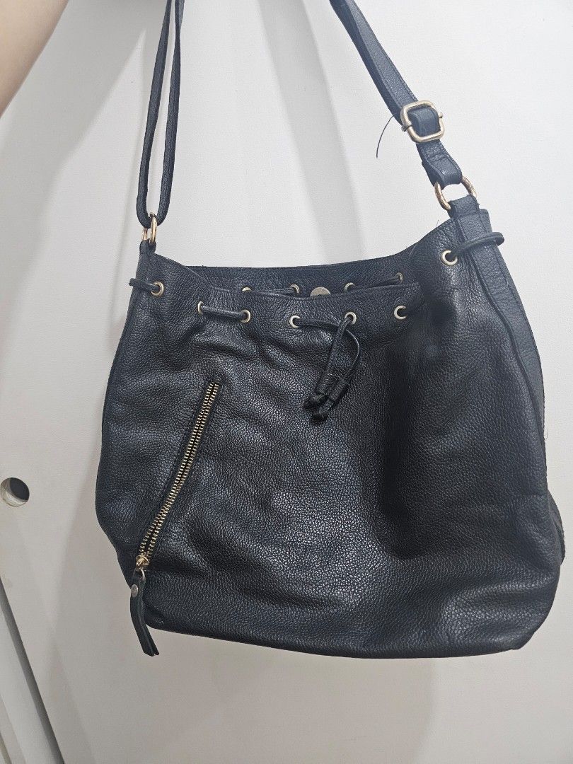 Costal Stella (Black) genuine leather bag (Category: Shoulder Bags) located in Quezon City. Submitted by jayjiess (Listing ID 1439786996, Image 1). Description: - Black textured leather shoulder bag - Magnetic snap closure + Drawstring - Adjustable strap to cross-body - Gold-colored buckle and hardware minor flaw: gold hardware needs polishing buyer shoulders s/f.