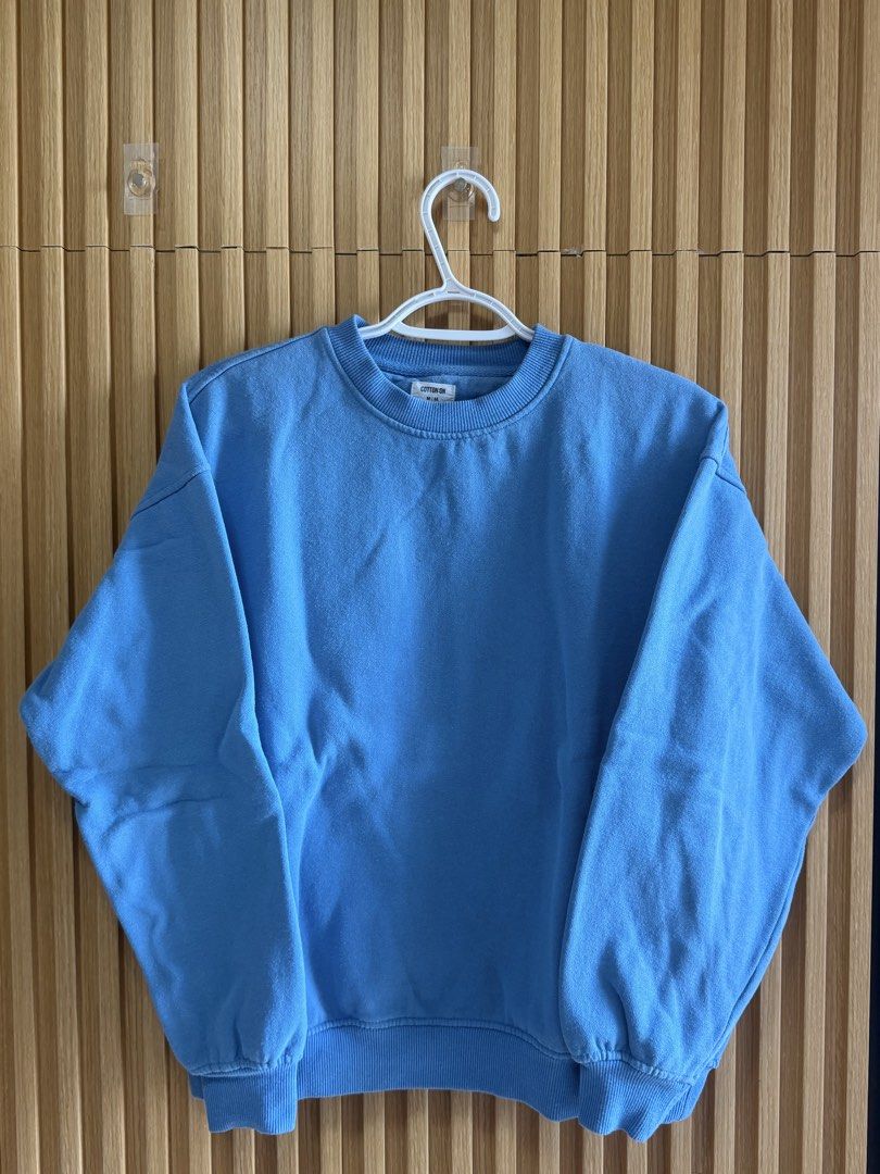 Cotton On Blue Sweatshirt - Size M (Category: Tshirts & Polo Shirts ) located in Cebu City. Submitted by dominicviado (Listing ID 1439686527, Image 1). Description: - Cotton On sweatshirt - Size: M - Color: Light Blue - Features: Crew neck, long sleeves - Made in China - Perfect for casual wear.