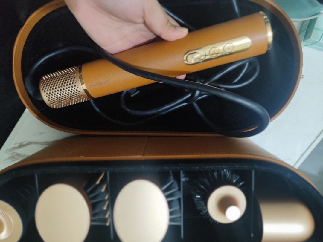 Dreame AirStyle Pro Multi High-Speed Styler 7-in-1 Hair Styler Curl, Volumize & Smooth (Category: Hair) located in Caloocan City. Submitted by aeliee (Listing ID 1439804323, Image 2). Description: - Includes multiple attachments: brush and barrel attachments - Comes with a storage case - Features a stylish brown leather-like finish with gold accents - Includes power cord RFS: too bulky to bring during travels .