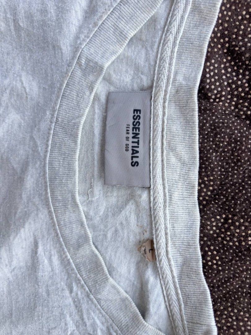 Fear of God Essentials T-shirt (Category: Tshirts & Polo Shirts ) located in Caloocan City. Submitted by wreps (Listing ID 1439615144, Image 3). Description: - Fear of God Essentials T-shirt - Color: Light Gray - Size: L - Features "ESSENTIALS" print on the chest - Made in Vietnam - Material: 100% Cotton - Brand tag and size tag included.