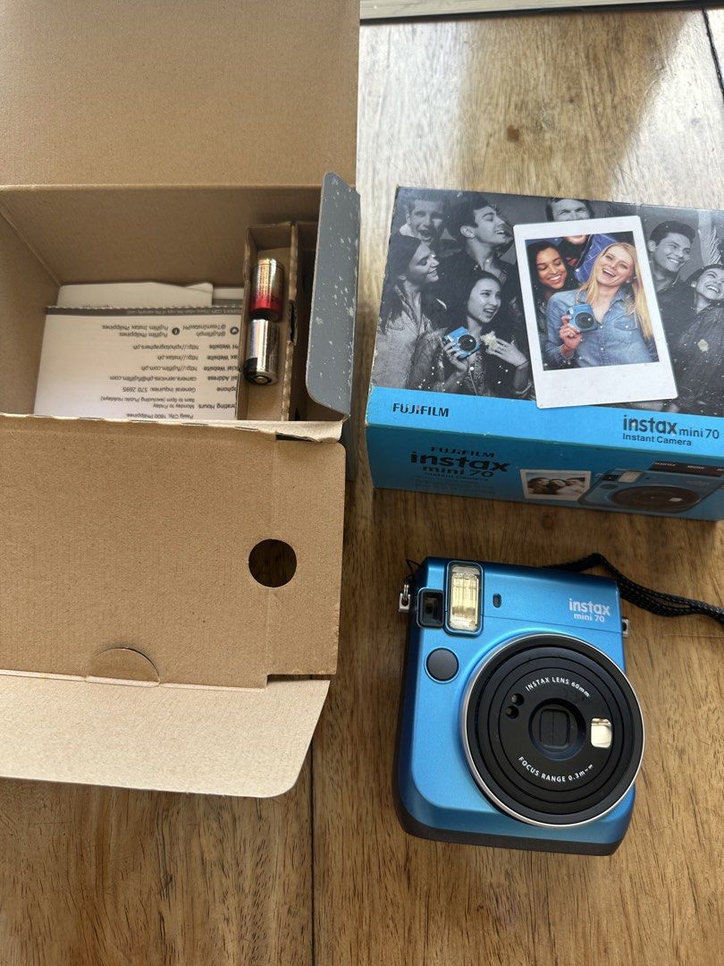 Fujifilm Instax Mini 70 Instant Camera (Category: Cameras) located in Manila. Submitted by ellie.copter (Listing ID 1439670829, Image 2). Description: - Fujifilm Instax Mini 70 instant camera (blue) - Includes original box, strap, and batteries - 60mm lens - Focus range: 0.3m - Features mode button and display screen - Film compartment accessible not properly tested, works with battery but lcd screen doesnt work - printing quality not tested with