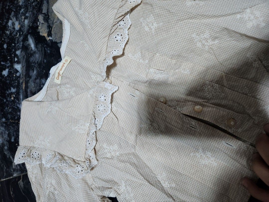 Gingersnap Beige Blouse with Lace Collar (Category: Babies & Kids Fashion) located in Santo Tomas. Submitted by anneiyayey (Listing ID 1439647371, Image 3). Description: - Beige blouse from Ginger Shops - Features a delicate lace collar - Long sleeves with stylish ruffled cuffs - Button-down front - Subtle checkered pattern - Made of lightweight fabric - Perfect for casual wear -10y on tag.