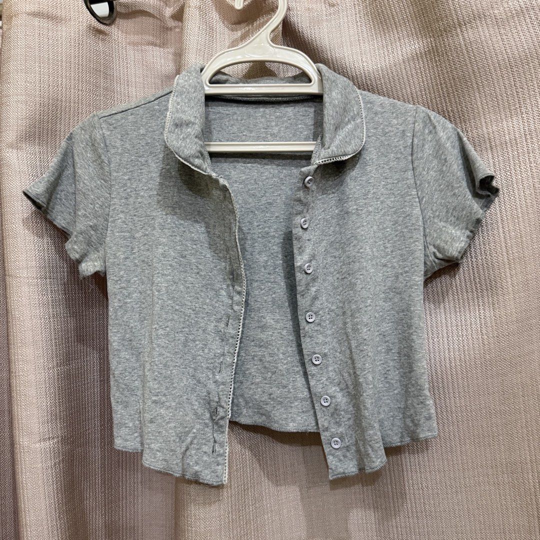 Grey Button-Up Crop Top (Category: Others Tops) located in Manila. Submitted by miss.v.declutter (Listing ID 1439771348, Image 1). Description: - Grey crop top - Collared neckline - Short sleeves - Button-up front - Soft material - Dress up or down - Perfect for layering.