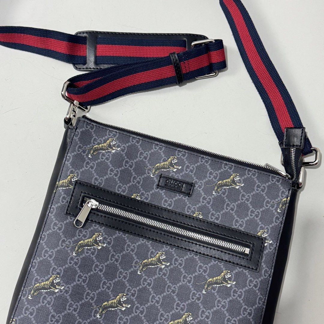 Gucci Tiger Print Messenger Bag (Category: Luxury Bags & Wallets) located in Dagupan City. Submitted by thriftygoods.dagupan (Listing ID 1439609237, Image 2). Description: - Authentic Gucci messenger bag - Tiger print design - Black leather trim - Striped shoulder strap - Front zipper pocket - Main compartment - Interior Gucci label with "Made in Italy" - Visible serial number.