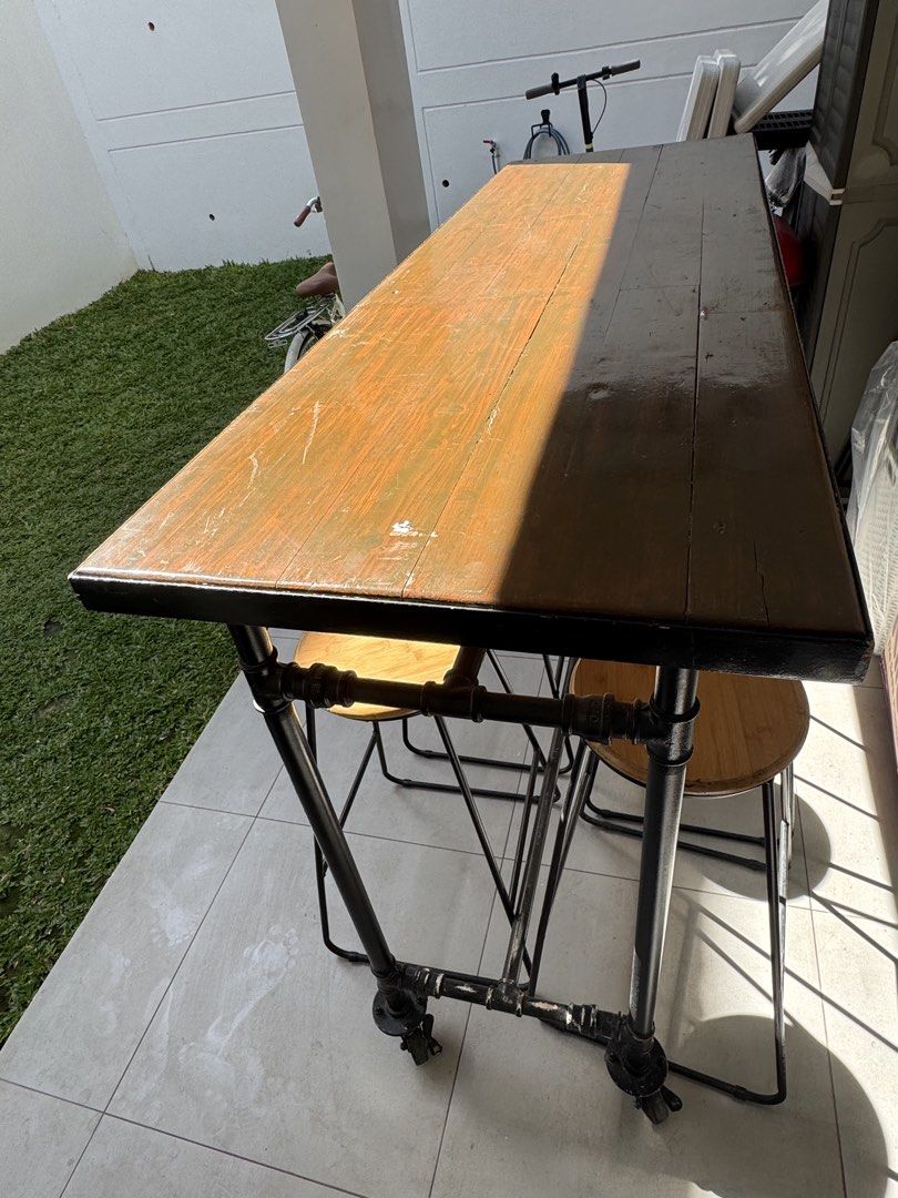 High table and chairs (Category: Tables & Sets) located in Paranaque City. Submitted by BOSS_G (Listing ID 1439611359, Image 3). Description: For sale! 1 High table solid wood and metal 10 High chairs solid wood and metal 8-10 comfortable seating Table is with wheels, easy to relocate Industrial style, Cozy Style Good for indoor and outdoor Heavy duty Please message before calling 09178210548 .