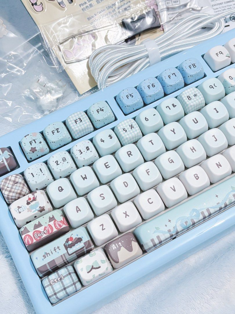 KiiBOOM Phantom 81 Lite Mechanical Keyboard (Category: Computer Keyboard) located in Manila. Submitted by cinnadump.2 (Listing ID 1439760694, Image 2). Description: KiiBOOM Phantom 81 Lite mechanical keyboard. Features 75% hot-swappable QMK/VIA RGB, 2.4Ghz/Bluetooth 5.0 wired mechanical keyboard. Includes original box, accessories, and keycaps. The keyboard has a light blue base with custom keycaps. Includes a USB-C cable..