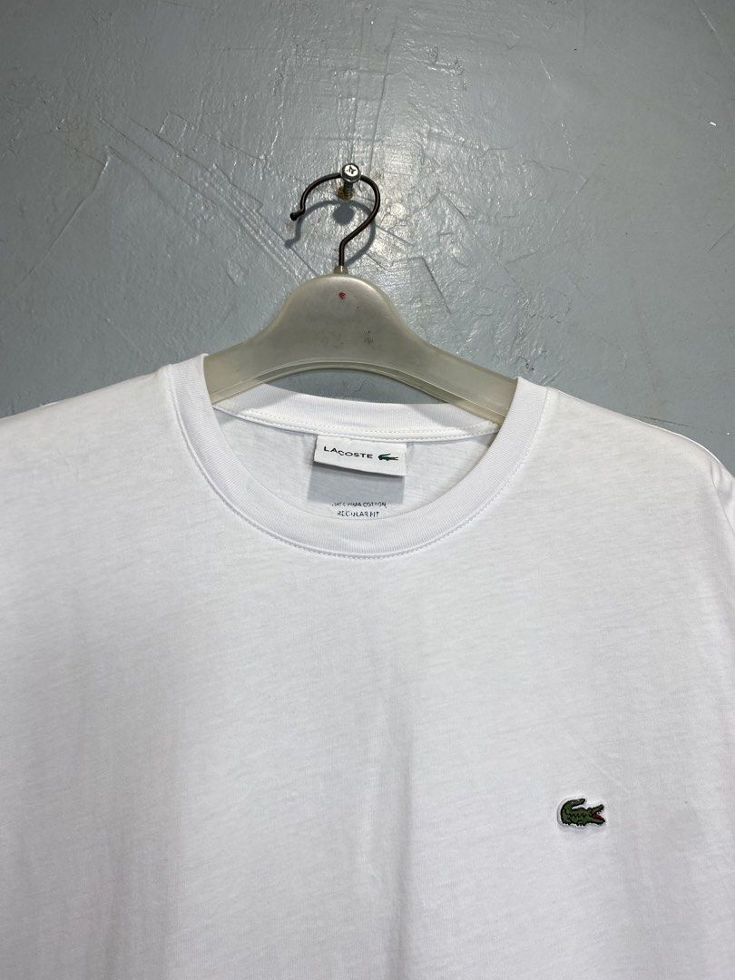 Lacoste White T-Shirt (Category: Tshirts & Polo Shirts ) located in Bacong. Submitted by crankneil (Listing ID 1439743419, Image 2). Description: Lacoste 🏷️ + 90 shipping fee -Dimes Width 22 Length 28.5 -Condition 9.5/10 -Color Rate 9.5/10 Excellent Condition Color may vary due to lightning Very Presentable when Worn Pinholes Need Wash Pm/Dm Visayas Dumaguete loc J&T Courier Express 🚛🚛🚛.