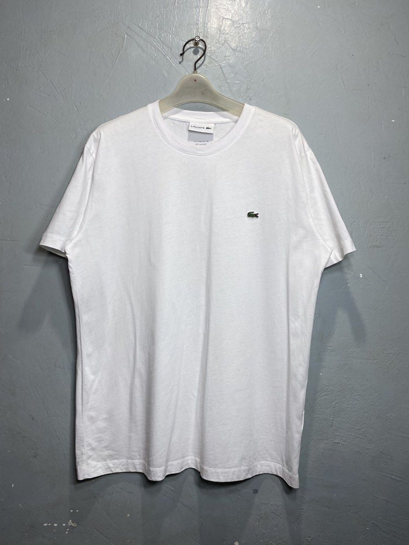 Lacoste White T-Shirt (Category: Tshirts & Polo Shirts ) located in Bacong. Submitted by crankneil (Listing ID 1439743419, Image 1). Description: Lacoste 🏷️ + 90 shipping fee -Dimes Width 22 Length 28.5 -Condition 9.5/10 -Color Rate 9.5/10 Excellent Condition Color may vary due to lightning Very Presentable when Worn Pinholes Need Wash Pm/Dm Visayas Dumaguete loc J&T Courier Express 🚛🚛🚛.