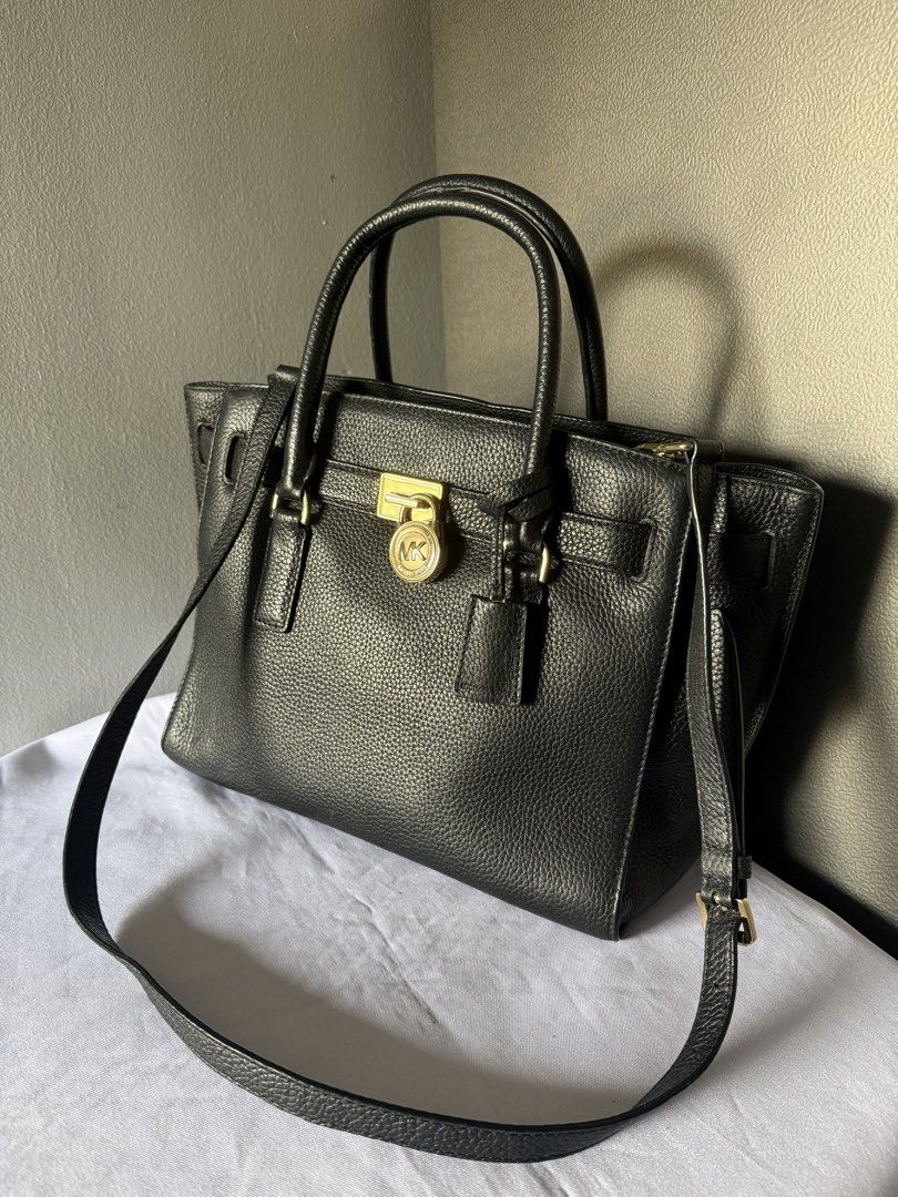 Medium Michael kors Hamilton pebble leather satchel (Category: Luxury Bags & Wallets) located in Davao. Submitted by rebaggedph (Listing ID 1439649717, Image 1). Description: Selling my Michael Kors Hamilton satchel. It’s a classic, versatile piece that fits everything you need for work or a day out! Condition: [9/10 – lightly used] Material: High-quality pebbled leather with gold-tone hardware Features: Iconic MK lock and key, sturdy top handles