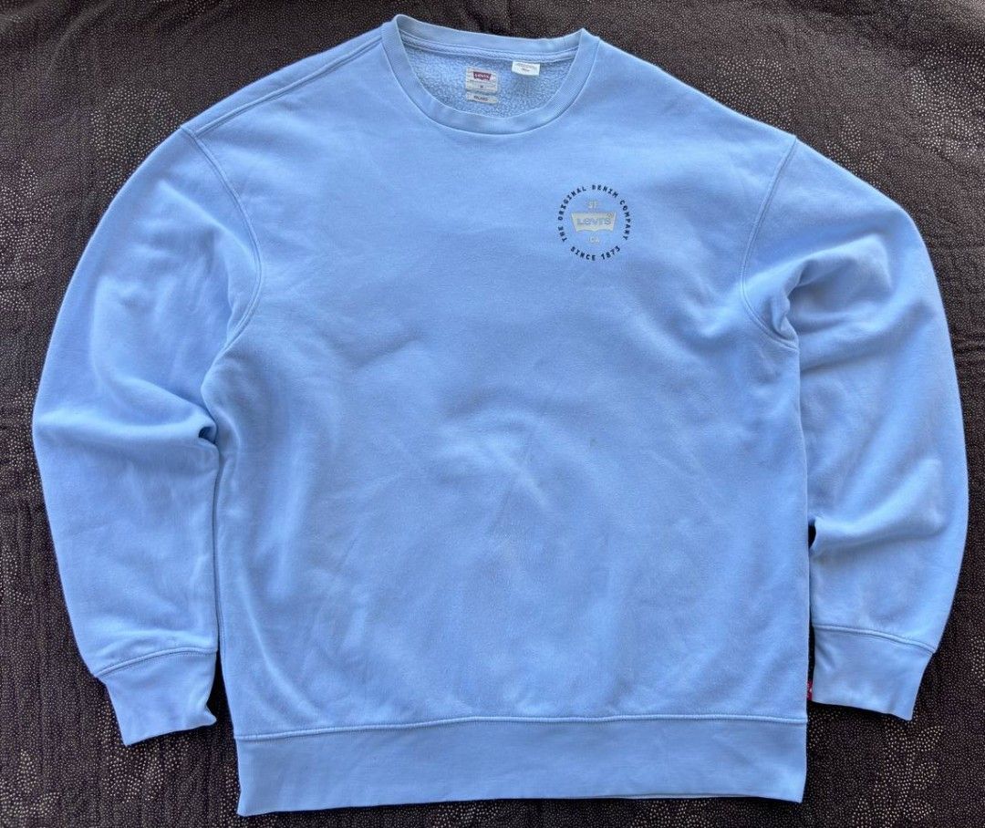 Levi's Relaxed Crewneck Sweatshirt - Medium (Category: Coats, Jackets and Outerwear) located in Caloocan City. Submitted by wreps (Listing ID 1439615373, Image 1). Description: - Levi's crewneck sweatshirt - Light blue color - Size: Medium (M) - Relaxed fit - Features Levi's logo on chest - Includes small red Levi's tag - Made in Vietnam.
