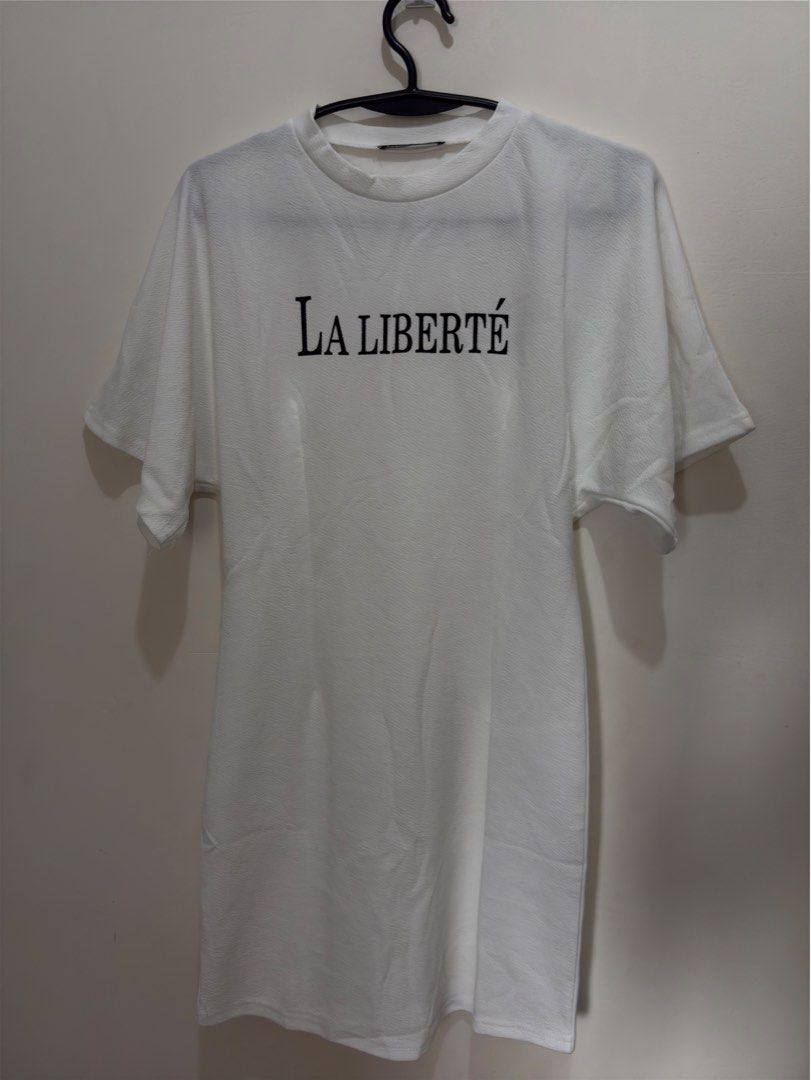 Lovito La Liberte White Dress (Category: Dresses) located in Quezon City. Submitted by mae_iggy (Listing ID 1439699257, Image 1). Description: - White dress with "La Liberte" print - Round neck - Short sleeves - Brand: Lovito - Size: 32M (EU 36, US 6) - Made in China.