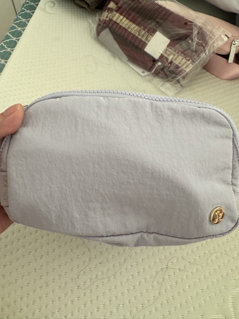 Lululemon Everywhere Belt Bag (Category: Cross-body Bags) located in Taguig. Submitted by pamraq (Listing ID 1439655064, Image 1). Description: - Lululemon Everywhere Belt Bag - Color: Light Purple - New with tags - Size: O/S - Dimensions: 5cm x 13cm x 13cm - Features a secure zipper closure - Includes a small gold Lululemon logo.