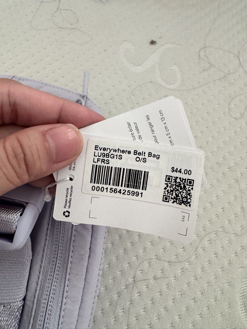 Lululemon Everywhere Belt Bag (Category: Cross-body Bags) located in Taguig. Submitted by pamraq (Listing ID 1439655064, Image 2). Description: - Lululemon Everywhere Belt Bag - Color: Light Purple - New with tags - Size: O/S - Dimensions: 5cm x 13cm x 13cm - Features a secure zipper closure - Includes a small gold Lululemon logo.
