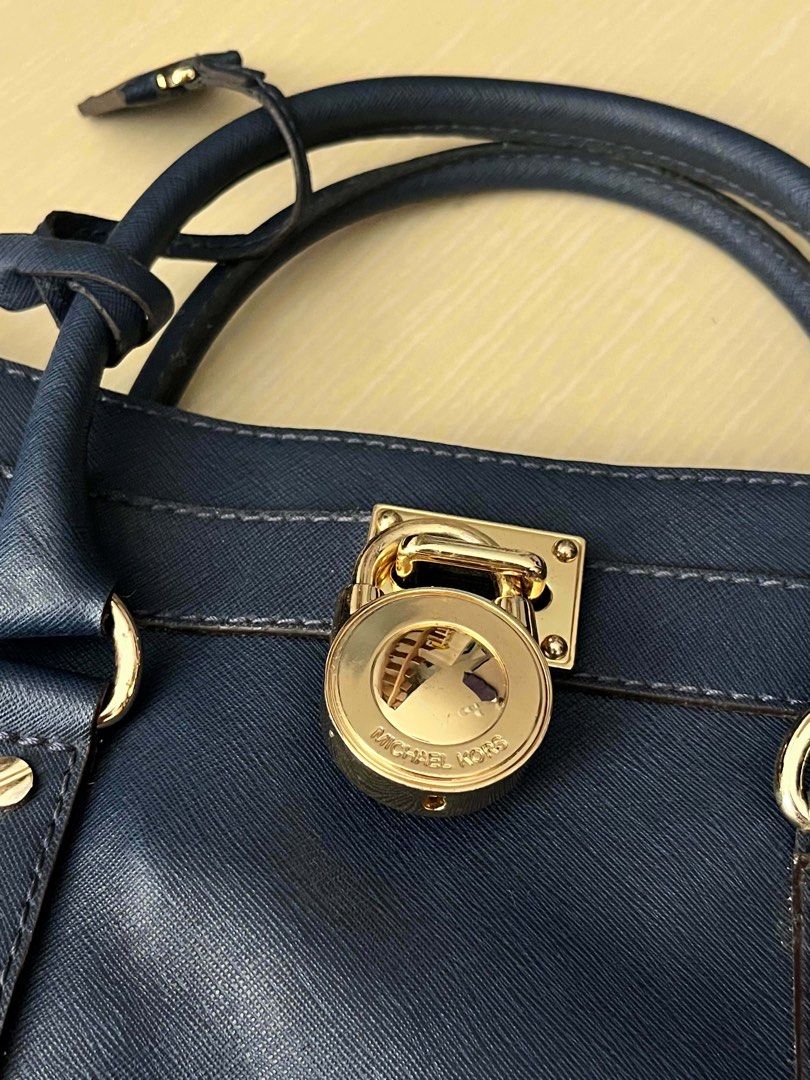 Michael Kors Hamilton Satchel Bag (Category: Luxury Bags & Wallets) located in Manila. Submitted by onnncl (Listing ID 1439650149, Image 2). Description: - Authentic Michael Kors Hamilton satchel - Navy blue color - Gold-tone lock and chain strap - Top handle and detachable tag - Includes dust bag.
