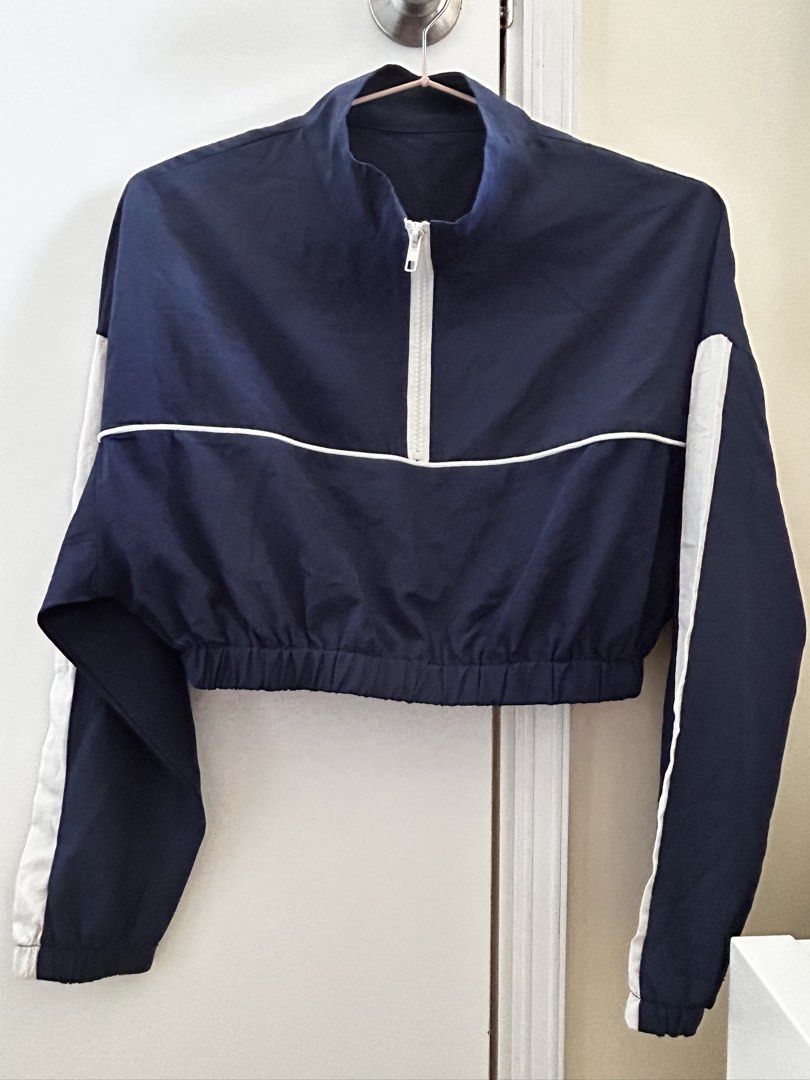 Navy Blue Cropped Jacket with White Stripes (Category: Coats, Jackets and Outerwear) located in Manila. Submitted by jaynojayno (Listing ID 1439618182, Image 1). Description: - Navy blue cropped jacket - White stripes on sleeves - Stand-up collar - White zipper - Elastic waistband - Long sleeves - Perfect for layering - Versatile for casual wear.