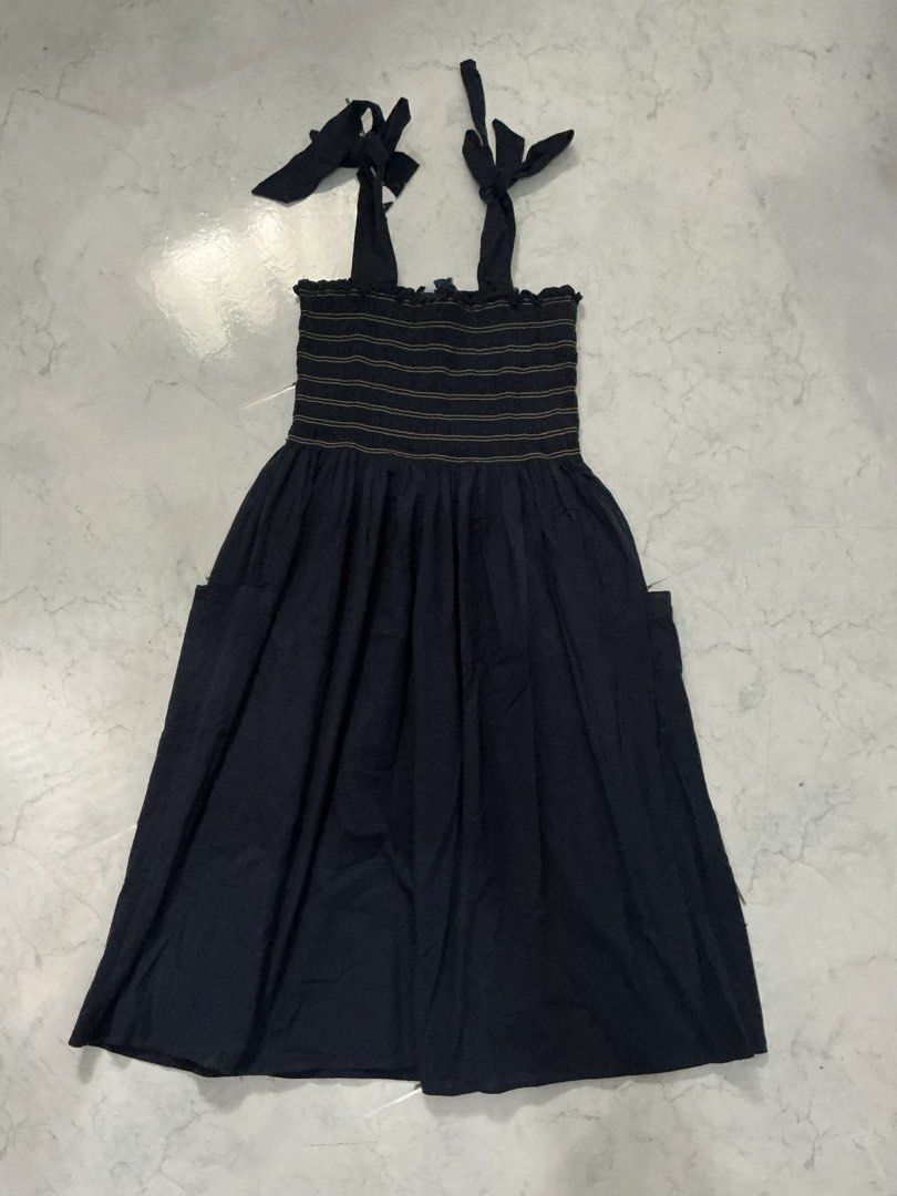 Navy Blue Tie-Strap Dress (Category: Dresses) located in Legazpi City. Submitted by clutterbusterph (Listing ID 1439692282, Image 1). Description: length: 37 inches - Navy blue midi dress - Tie straps - Smocked bodice with gold accents - Flowing skirt - Pockets on both sides - Versatile for casual wear.