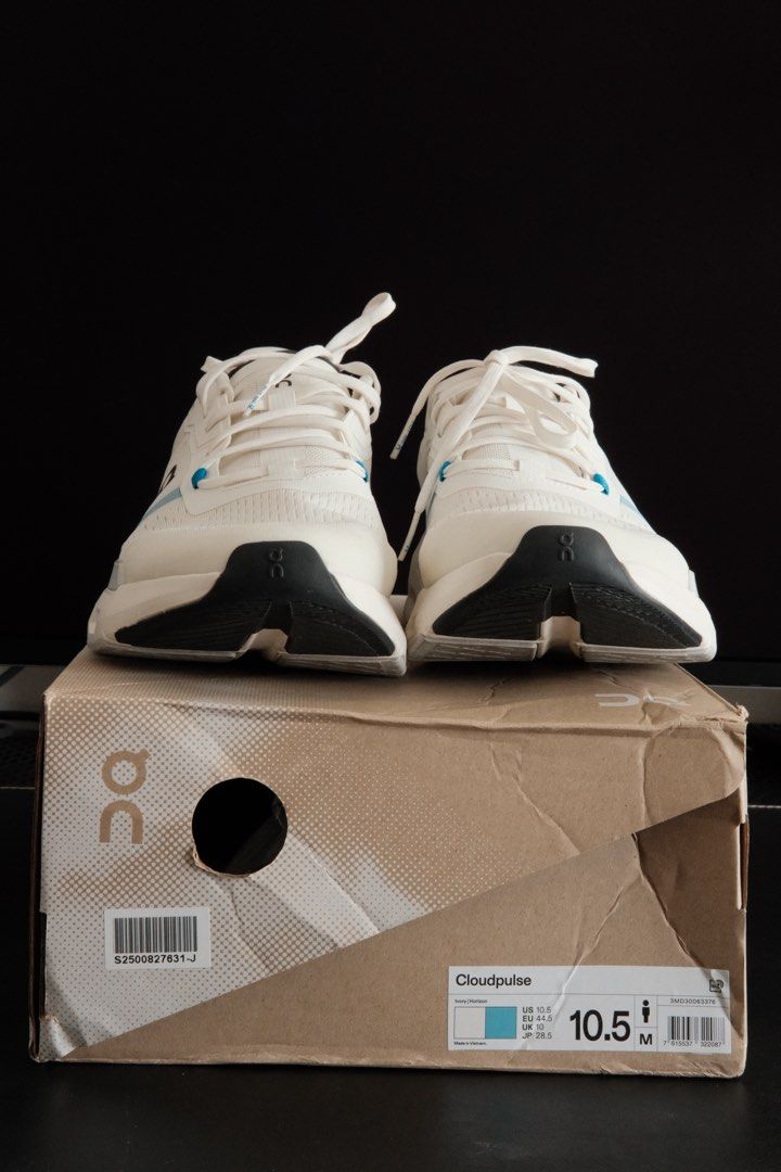 On Cloudpulse (Category: Sneakers) located in Kuala Lumpur. Submitted by hadibass (Listing ID 1439656065, Image 1). Description: - On Cloudpulse running shoes - White color with blue accents - Size: 10.5 US men's - CloudTec sole for superior cushioning - Includes original box - Features white laces - On logo visible on the side - Sole color: Black and grey.