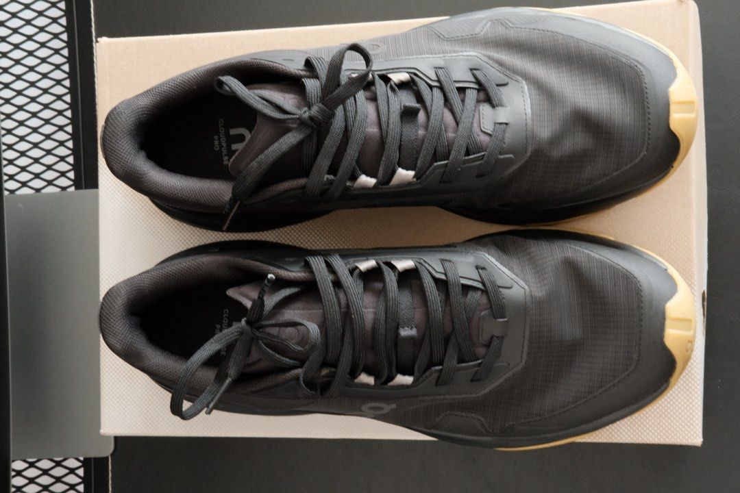 On Cloudpulse Pro - Black (Category: Sneakers) located in Kuala Lumpur. Submitted by hadibass (Listing ID 1439655261, Image 3). Description: - On Cloudpulse Pro running shoes - Color: Black upper with tan sole - Size: US 11 - Includes original box - Features laces - On logo visible on side and sole - Condition: worn once For weightlifting.