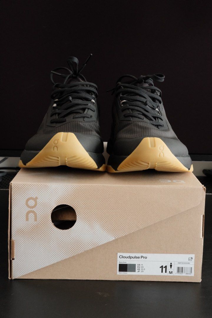 On Cloudpulse Pro - Black (Category: Sneakers) located in Kuala Lumpur. Submitted by hadibass (Listing ID 1439655261, Image 1). Description: - On Cloudpulse Pro running shoes - Color: Black upper with tan sole - Size: US 11 - Includes original box - Features laces - On logo visible on side and sole - Condition: worn once For weightlifting.