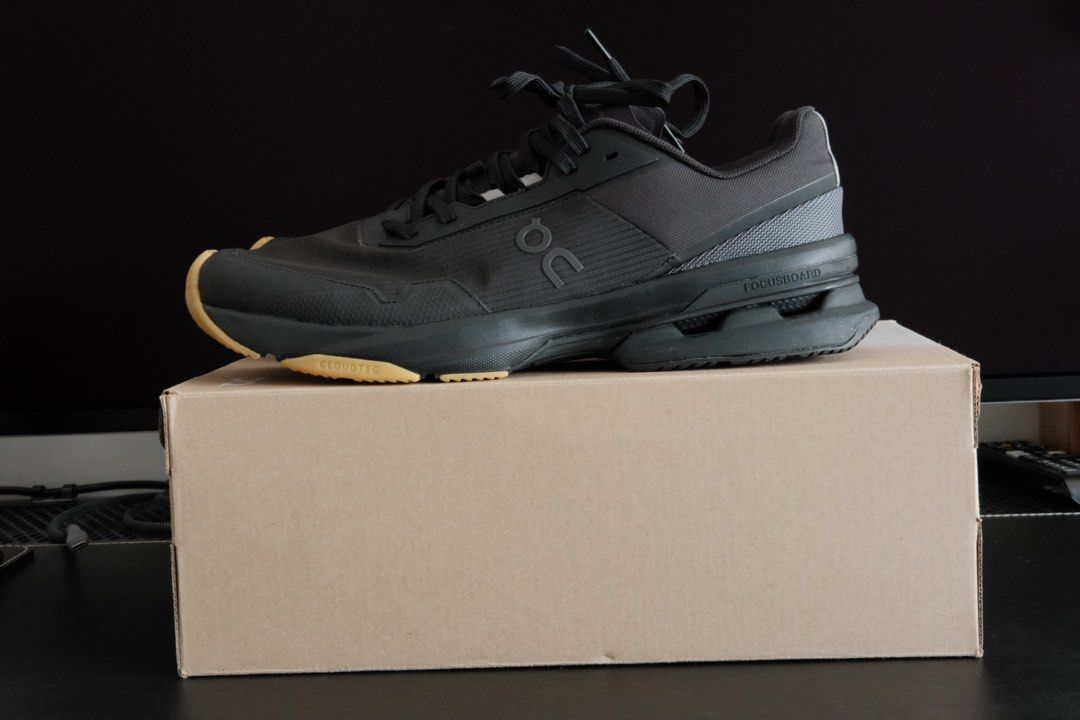 On Cloudpulse Pro - Black (Category: Sneakers) located in Kuala Lumpur. Submitted by hadibass (Listing ID 1439655261, Image 2). Description: - On Cloudpulse Pro running shoes - Color: Black upper with tan sole - Size: US 11 - Includes original box - Features laces - On logo visible on side and sole - Condition: worn once For weightlifting.