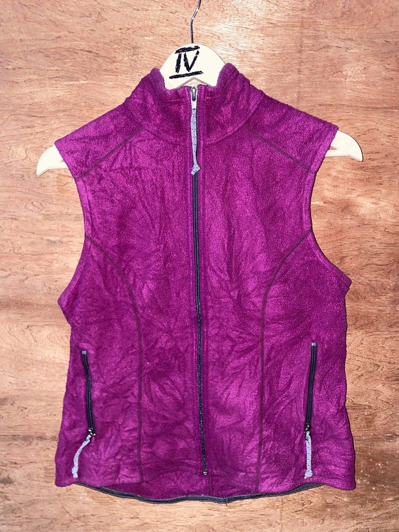 Patagonia Fleece Vest (Category: Others Tops) located in Puerto Princesa. Submitted by earlpogitrhift (Listing ID 1439608257, Image 1). Description: Patagonia fleece vest features a full zip closure and two zippered pockets. It has a high collar and a purple exterior with grey accents. The Patagonia logo is visible on the back of the collar..