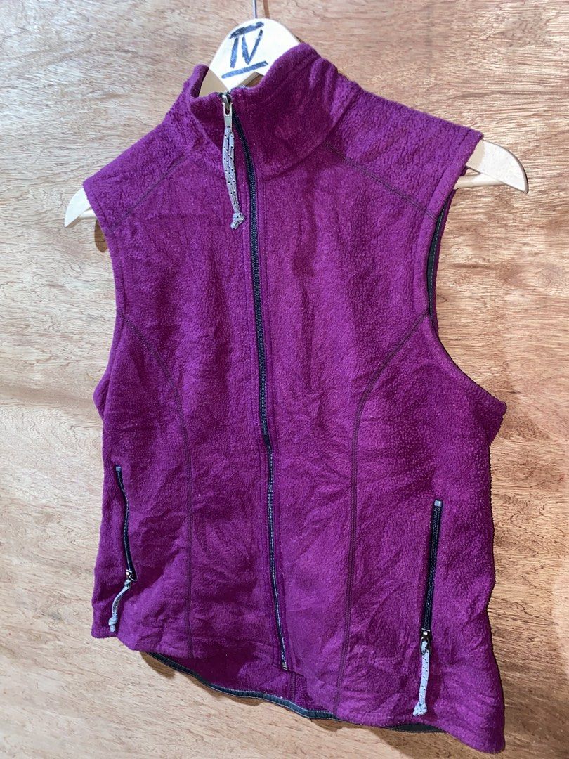 Patagonia Fleece Vest (Category: Others Tops) located in Puerto Princesa. Submitted by earlpogitrhift (Listing ID 1439608257, Image 3). Description: Patagonia fleece vest features a full zip closure and two zippered pockets. It has a high collar and a purple exterior with grey accents. The Patagonia logo is visible on the back of the collar..