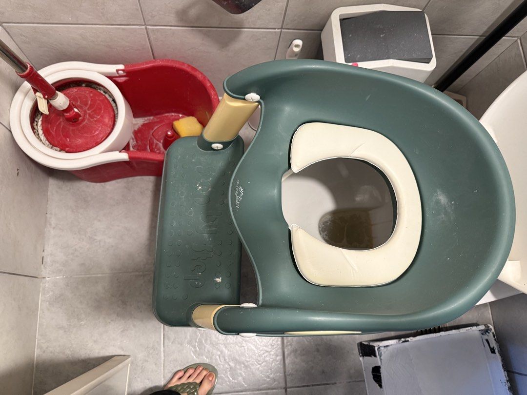 Potty Training Toilet Seat (Category: Toilet Training) located in Makati City. Submitted by rockandraw (Listing ID 1439741443, Image 2). Description: - Fits standard toilets - Green seat with white cushion - Features handles for security - Helps with potty training.