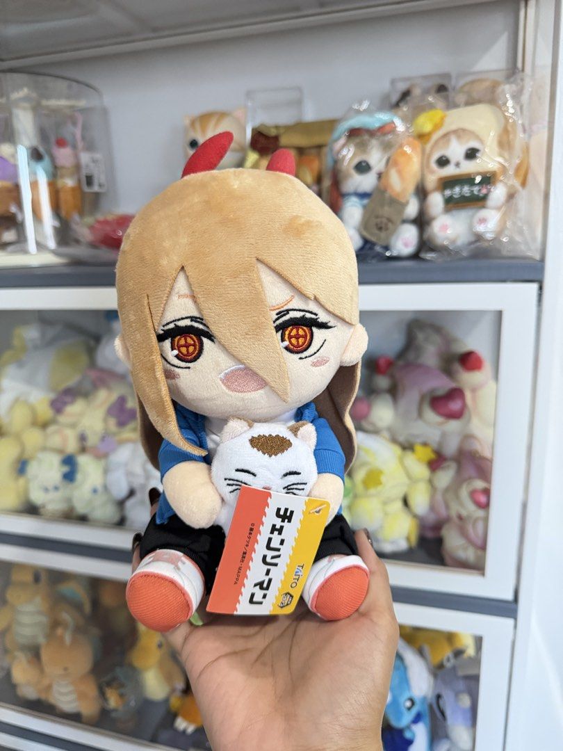 Power Chainsaw Man Small Taito Plush Toy (Category: Plushies & Soft Toys) located in Cavite. Submitted by strawberrycakeshoppu (Listing ID 1439794492, Image 1). Description: - Chainsaw Man Power plush toy - Features Power holding a small cat plush - Includes a tag - Power's outfit: blue jacket, black pants, orange shoes - Red horns and orange eyes - Perfect for Chainsaw Man fans!.