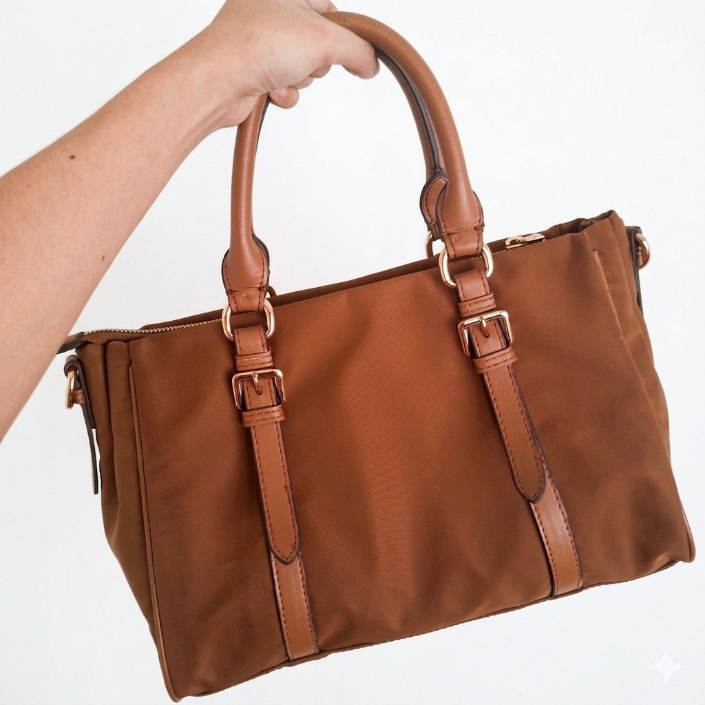 Prada Caramel Brown Nylon Handbag with Strap (Category: Luxury Bags & Wallets) located in Manila. Submitted by ixshibixi (Listing ID 1439714930, Image 2). Description: N0T AUTH. Preloved, rarely used, but due to high humidity and improper storage, it has shown signs of wear. Flaws: Both handles, bottom leather accent lines, and the identification holder show slight peeling on the leather, as seen in the photos. The flaws are relatively unnoticeab