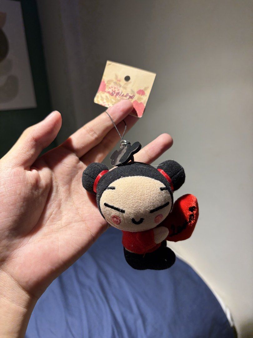 Pucca Plush Keychain (Category: Plushies & Soft Toys) located in Makati City. Submitted by squishycorner (Listing ID 1439768385, Image 1). Description: - Adorable Pucca plush keychain - Features Pucca in her signature red outfit - Holding a red heart - Includes the original tag - Perfect for fans or as a cute accessory.