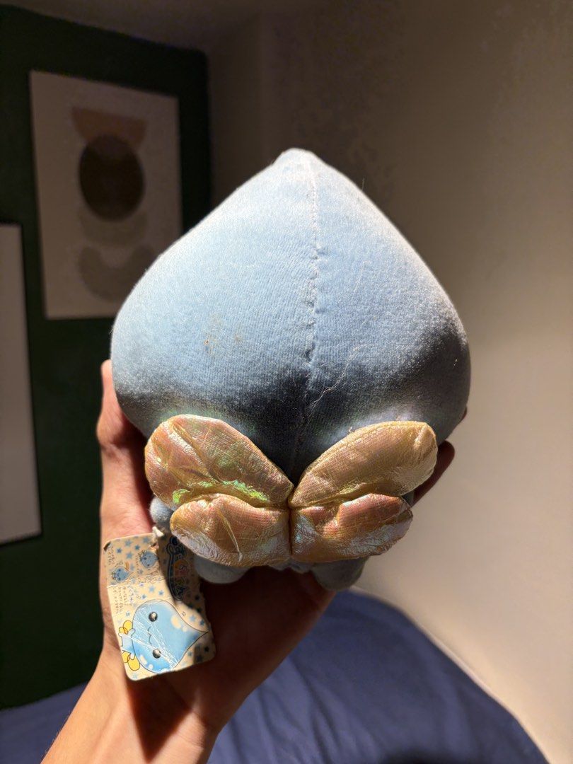 Q-lia Blue Plush with Tag (Category: Plushies & Soft Toys) located in Makati City. Submitted by squishycorner (Listing ID 1439767777, Image 2). Description: - Cute light blue blob plush toy - Brand new with tag - Features a soft texture - Adorable smiling face - Unique design on the bottom - Perfect for collectors or gifts.