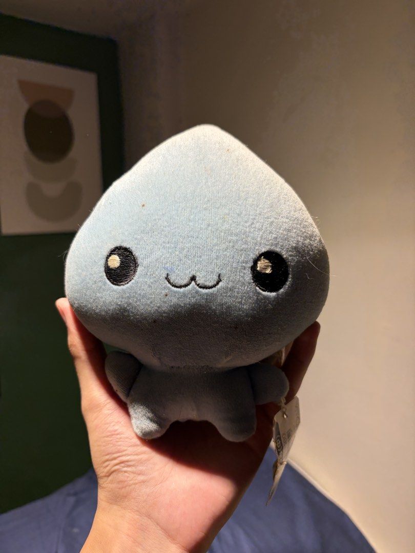 Q-lia Blue Plush with Tag (Category: Plushies & Soft Toys) located in Makati City. Submitted by squishycorner (Listing ID 1439767777, Image 1). Description: - Cute light blue blob plush toy - Brand new with tag - Features a soft texture - Adorable smiling face - Unique design on the bottom - Perfect for collectors or gifts.