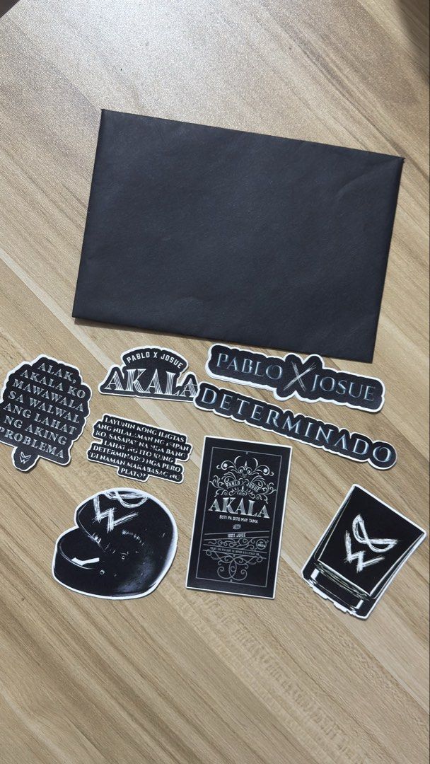 SB19 Pablo X Josue Akala Determinado Sticker Pack (Category: Art & Prints) located in Quezon City. Submitted by amillionsuns (Listing ID 1439795023, Image 1). Description: - Akala sticker set - Features various designs and quotes - Includes stickers with 'Akala,' 'Determinado,' and other text - Black and white color scheme - Comes with a black envelope - Ideal for Akala and Pablo X Josue fans.