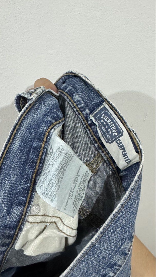 Signature Levi Strauss & Co. Carpenter Jeans (Category: Jeans) located in Manila. Submitted by eddy_ramos (Listing ID 1439685541, Image 3). Description: - Levi Strauss & Co. Carpenter Jeans - Light blue wash - Distressed details - Straight leg fit - Multiple pockets (including carpenter pocket) - Issue: holes.