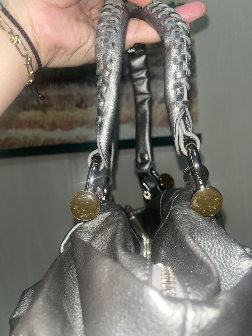 Silver Handbag with Braided Handles (Category: Luxury Bags & Wallets) located in Quezon City. Submitted by edmrubi (Listing ID 1439719820, Image 3). Description: - Silver handbag - Braided handles - Zippered main compartment - Multiple interior pockets - Textured exterior - Silver hardware - Top handle and shoulder strap - Gray interior lining - Drawstring detail on sides.