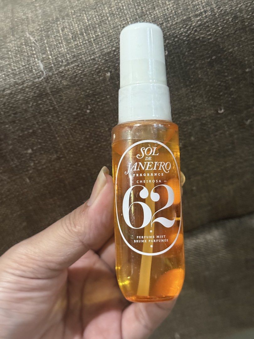 Sol de Janeiro Cheirosa '62 Perfume Mist (Category: Fragrance & Deodorants) located in Makati City. Submitted by definehipster (Listing ID 1439773496, Image 1). Description: - Sol de Janeiro Cheirosa '62 Perfume Mist - Size: 1 fl oz / 30 ml - AUTHENTIC - Fragrance notes: Pistachio, salted caramel, vanilla - Made in USA - Orange bottle - Ingredients and batch code on the bottom RFS: dont like the smell & decluttering.