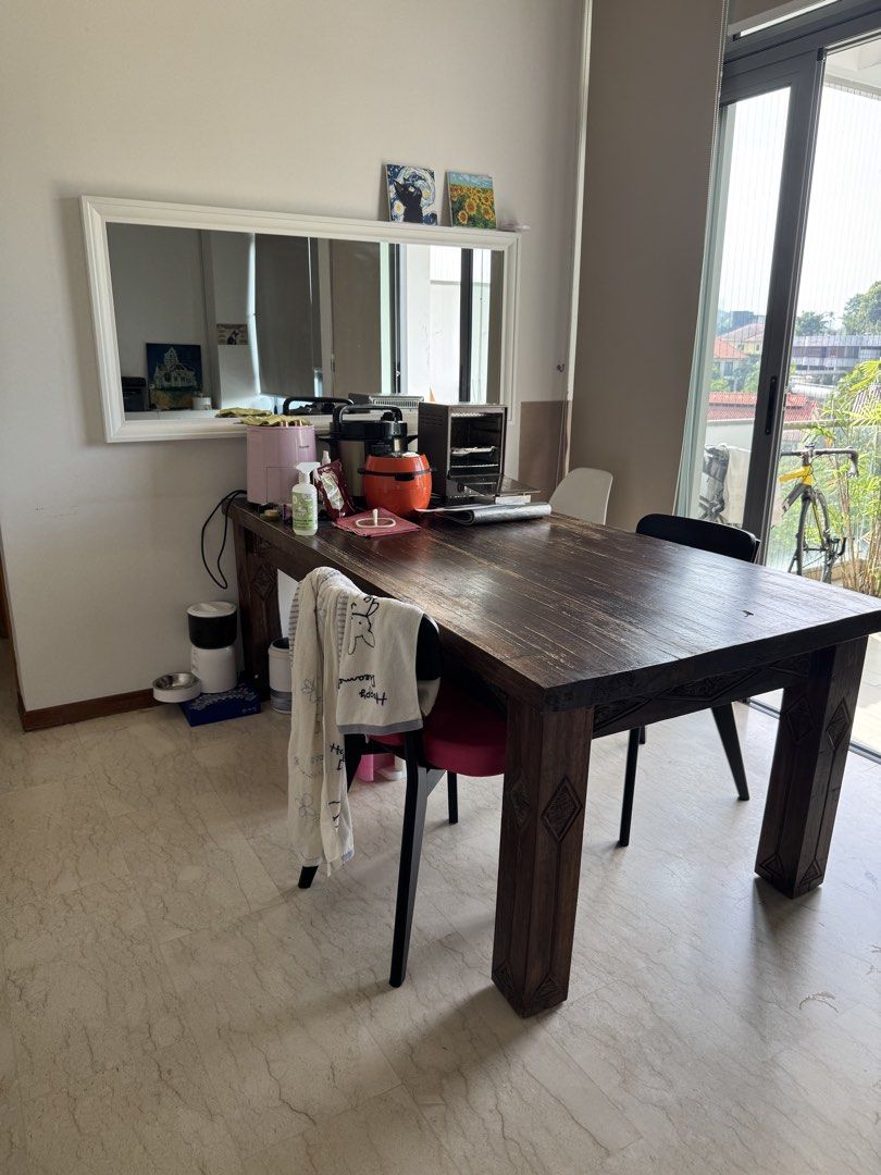 Solid Wood Dining Table - Rustic Charm (Category: Tables & Sets) located in Singapore. Submitted by caffeline_by_jupiter (Listing ID 1439673822, Image 1). Description: - Solid wood dining table - Dark wood finish - Intricate carvings on legs - Perfect for family meals or entertaining - Sturdy and ready for a new home Size 2m x 97 cm.