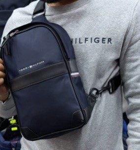 Tommy Hilfiger Backpack (Category: Backpacks) located in Manila. Submitted by declutter_with_cmb (Listing ID 1439618465, Image 1). Description: - Navy blue Tommy Hilfiger backpack with black accents - Top handle and adjustable shoulder straps - Main compartment with zipper closure - Original price: $119.00 - Tommy Hilfiger logo on the front.