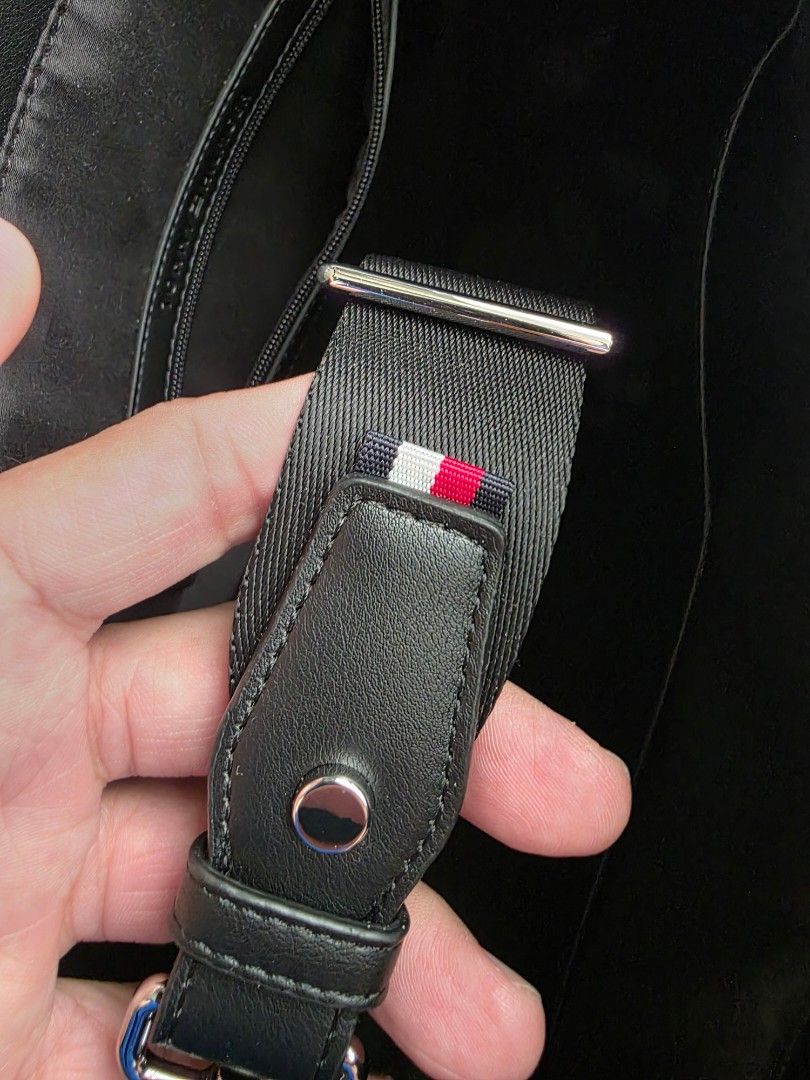 Tommy Hilfiger Black Tote Bag (Category: Tote Bags) located in Makati City. Submitted by chris_angle (Listing ID 1439621002, Image 2). Description: - Tommy Hilfiger black tote bag - Used 2x only - Structured design - Dual handles and detachable shoulder strap - Minimalist aesthetic - Subtle embossed details - Features strap with Tommy Hilfiger signature colors Dimensions: ● Width 34cm • Depth 12cm • Height 40cm • Minimum strap length 97cm • Maxim