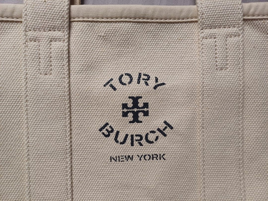 Tory Burch Canvas Tote Bag (Category: Luxury Bags & Wallets) located in Rizal. Submitted by raishin_listings (Listing ID 1439759444, Image 3). Description: - Authentic Tory Burch tote bag - Canvas exterior - Leather handles - Tory Burch logo on front - Minor yellowish stain inside - Black leather handles with white stitching - Perfect for everyday use.