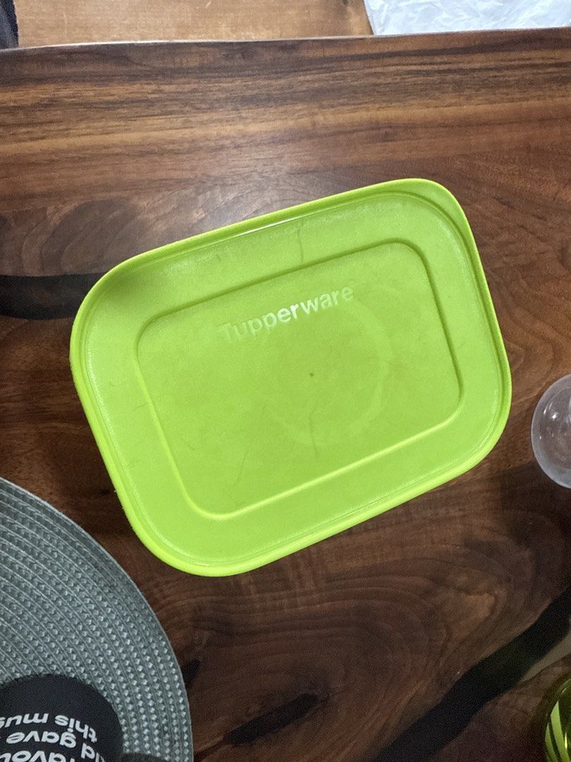 Tupperware Rectangular Food Container (Category: Food Organisation & Storage) located in Singapore. Submitted by anjali1504 (Listing ID 1439607949, Image 1). Description: - Rectangular Tupperware container, freezer safe - Bright green lid - Perfect for storing leftovers - Great for packing lunches - Ready for use.