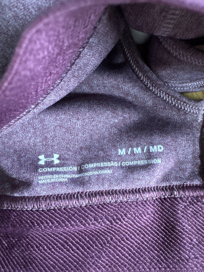 Under Armour Sports Bra (Category: Activewear) located in Baliuag. Submitted by mkcabling (Listing ID 1439615265, Image 3). Description: - Under Armour sports bra - Cross-back design - Removable Padding - Color: Purple-grey with a darker purple band - Under Armour logo on band - Made of stretchy material - Ideal for athletic activities -used once - RFS: Decluttering.