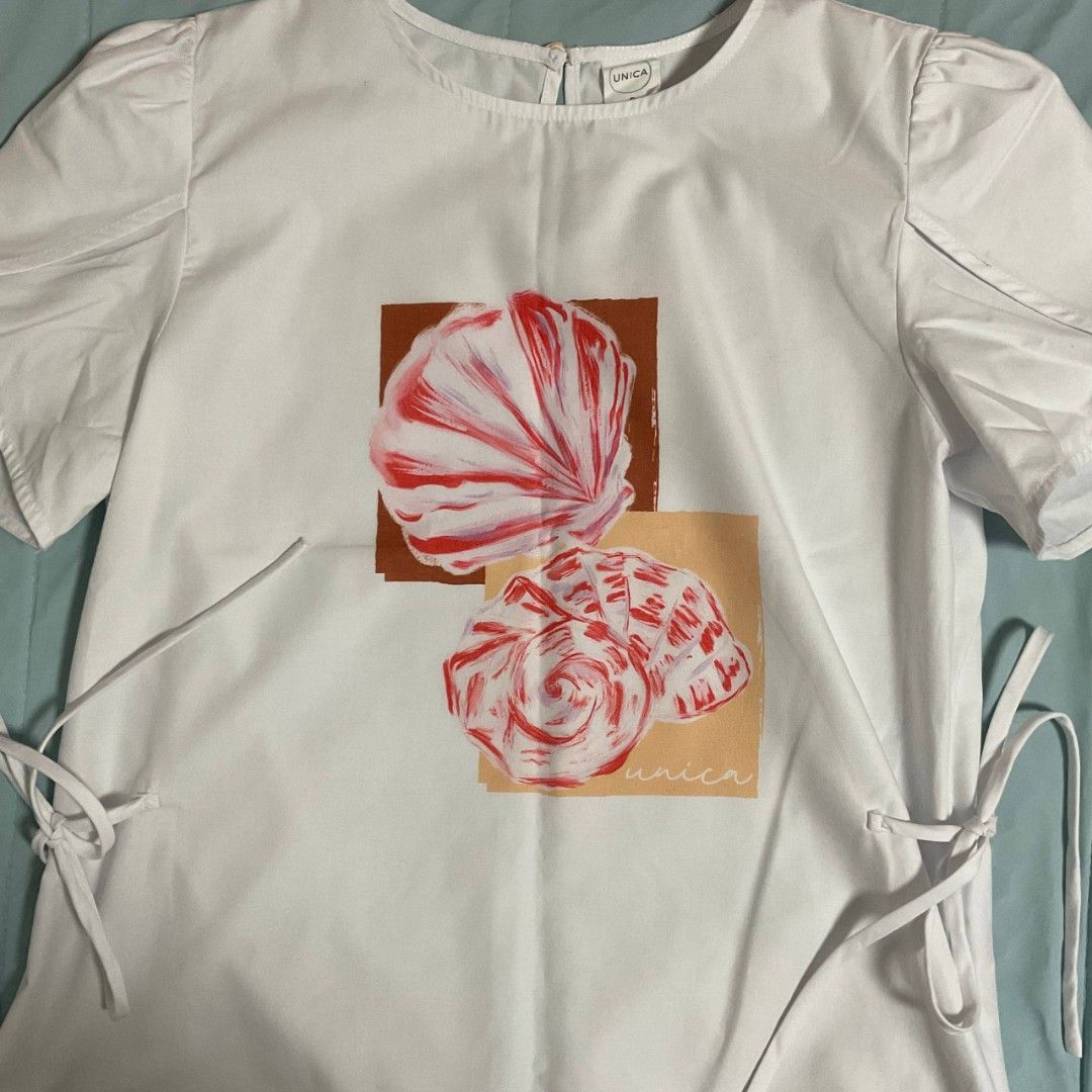 Unica White Pink Shell Summer Print Top S (Category: Sleeveless) located in Paranaque City. Submitted by prelovedby.aly (Listing ID 1439732035, Image 2). Description: Unica white top with shell print. Features short sleeves, tie sides, round neckline, and keyhole back. Relaxed fit..