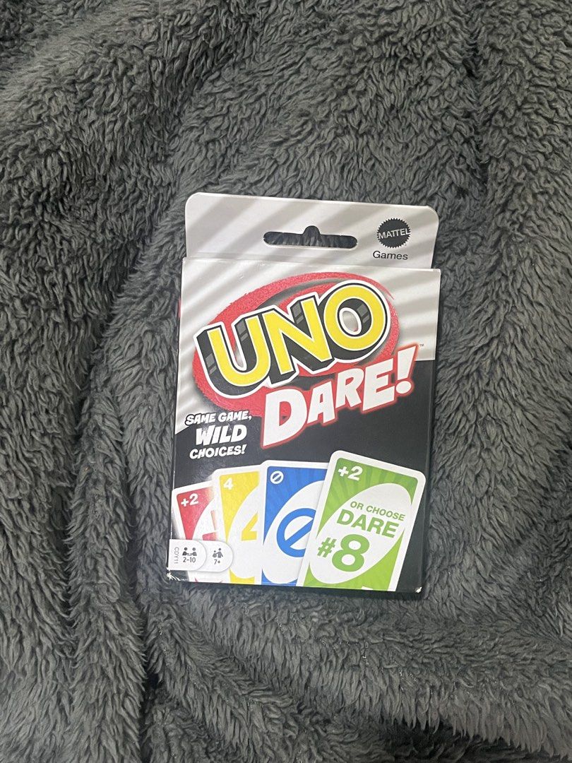 Uno Dare Card Game (Category: Board Games & Puzzles) located in Manila. Submitted by ocellus (Listing ID 1439625850, Image 1). Description: - Uno Dare! card game - Includes action cards with draw-two or dare options - Features 3 dare categories with 16 dares each - Contains 112 cards - For 2-10 players - Get ready for a fun game night!.